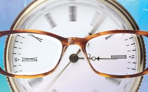 An image of glasses over a clock