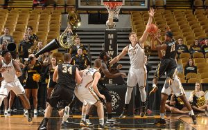 JJ Panoske blocks a shot while playing basketball for UWM