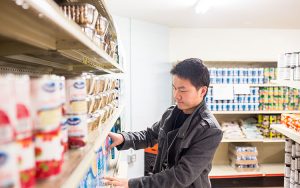 A UWM student volunteers at the Hope House food pantry.