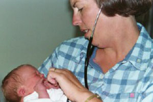 Teresa Johnson holds a baby.