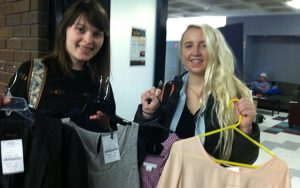 Cassandra Rasch (left), junior in communication sciences and disorders, and Makensie Gustafson, senior in conservation and environmental science, show off a couple of finds in the Career Closet. (UWM Photo/Kathleen Quirk)