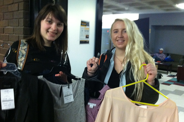 Cassandra Rasch (left), junior in communication sciences and disorders, and Makensie Gustafson, senior in conservation and environmental science, show off a couple of finds in the Career Closet. (UWM Photo/Kathleen Quirk)