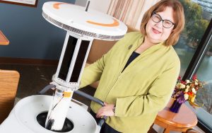 Christine Kovach and a robot at a nursing home.