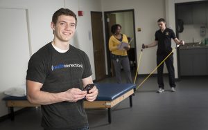 Jordan Mather, a senior marketing student, built a mobile platform that allows health-care providers to communicate with their patients through HIPAA-compliant instructional videos, messaging and visual progress tools. The app also allows patients to store shared information to review later. That could, for example, prevent physical therapy patients from losing their exercise instructions. (UWM Photo/Troye Fox)