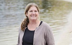 Sandra McLellan standing by water