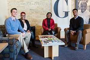 Tiffinie Cobb has been working with Dave Celata (from left), Danae Davis and Lamont Smith during her internship at Milwaukee Succeeds. (UWM Photo/Troye Fox)