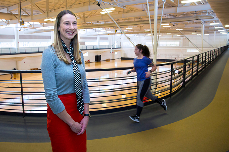Stacy Gnacinski stands in the Klotsche Center as a jogger goes past.