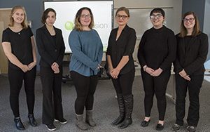 Students stand while posing for a photo.
