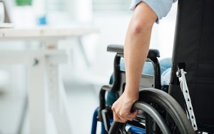 Hand on wheelchair wheel