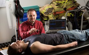 Graduate student David Cornell measuring a person's heart rate