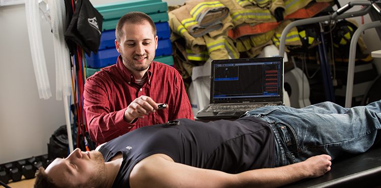 Graduate student David Cornell measuring a person's heart rate
