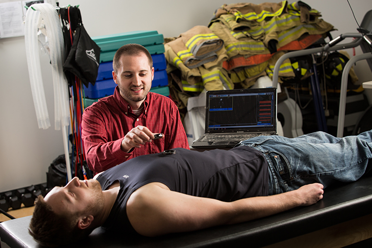 Graduate student David Cornell measuring a person's heart rate