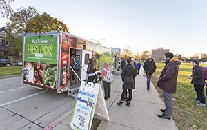 People stand outside the truck.