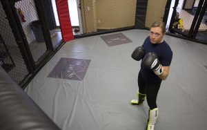 Leah Letson posing for a picture in a UFC-style fighting cage.