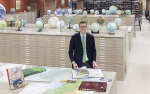 John Reuter stands in the American Geographical Society Library at UWM.