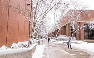 Students walk through the snow on the UWM campus.