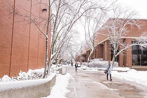 Students walk through the snow on the UWM campus.