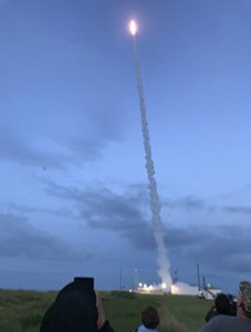 A plume of smoke follows the rocket into the sky.