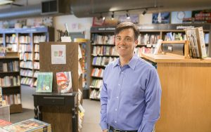 A man stands in a bookstore.