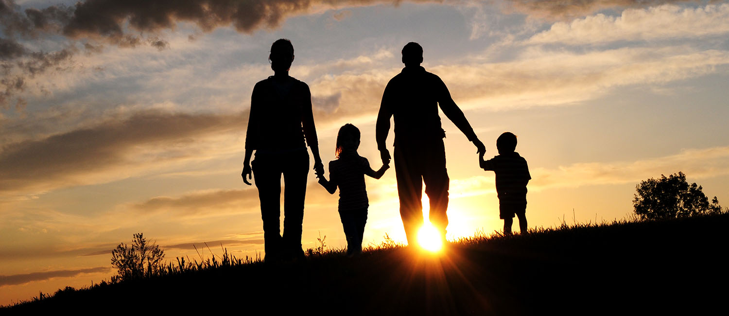 Image of a family at sunset.