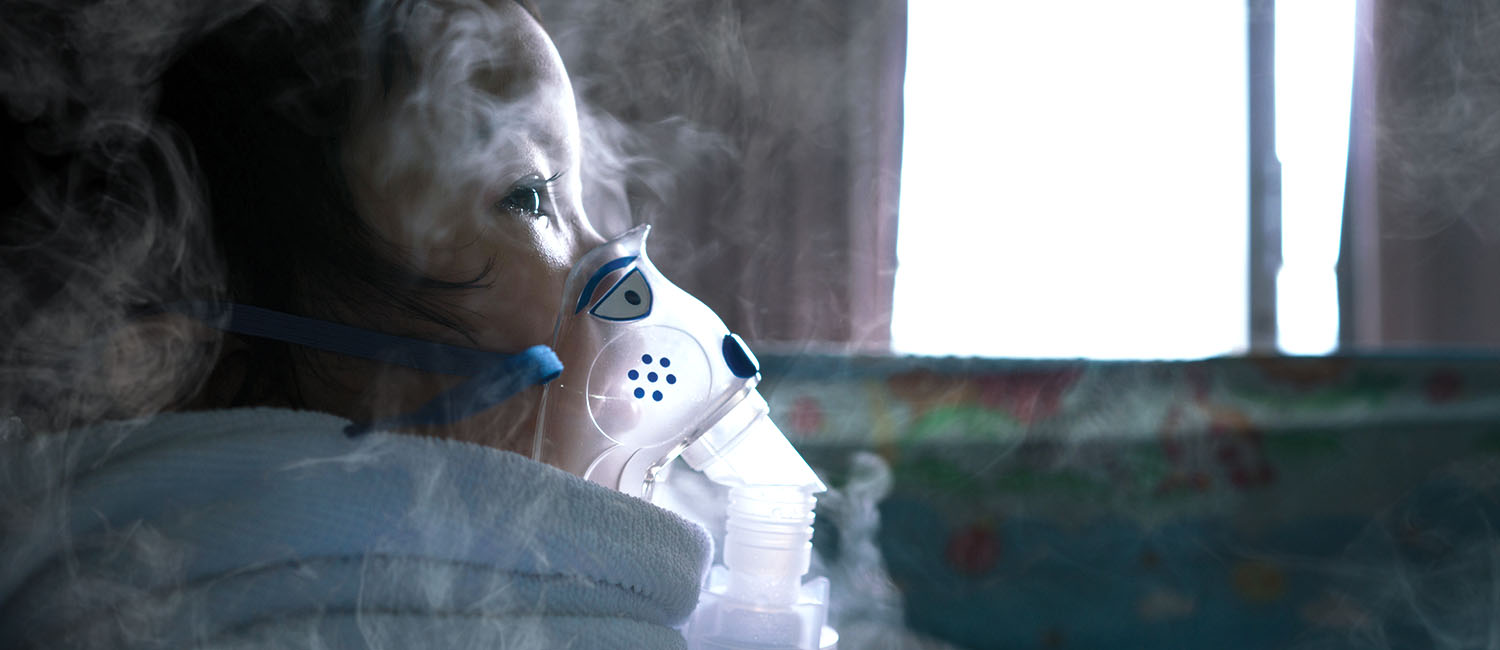 Image of a child wearing a mask to protect her from smoke