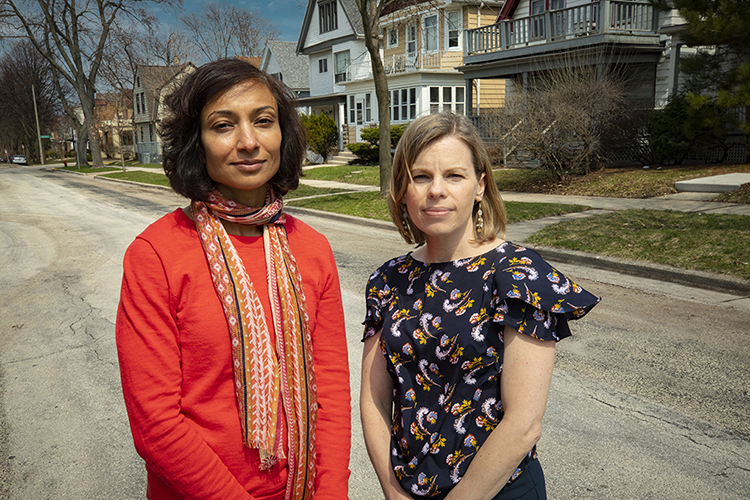 Two women pose stand in a Milwaukee neighborhood.