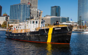 Photo of a research boat sailing off shore of downtown Milwaukee