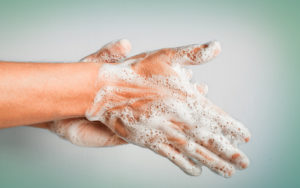 Hands being washed with soap