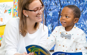 A woman reads a book to a child