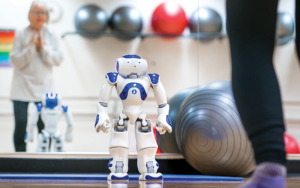 Eye-level with a small robot in a fitness space with exercise balls
