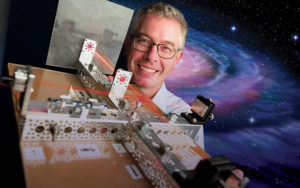 Patrick Brady shows off a model of LIGO