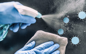 Illustration of hand directing a spray bottle at Covid-19 virus