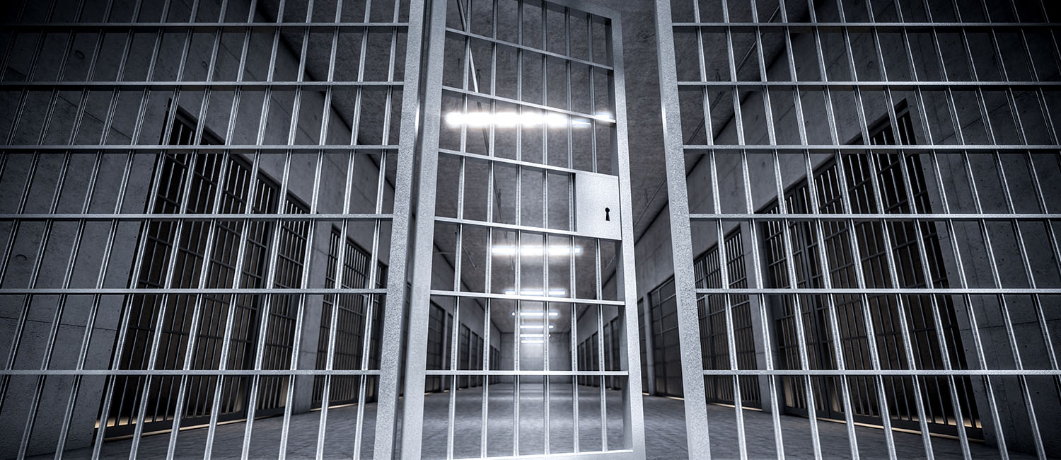 Empty jail cell with partially open door