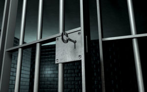 Empty jail cell with partially open door