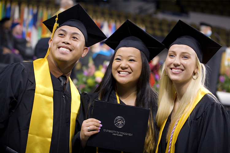 Graduates smile for a photo