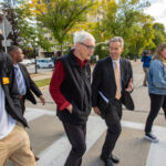 Crossing the street,UW Milwaukee Chancellor Mark Mone on a tour through campus with Wisconsin Governor Tony Evers and students, Caleb Jones and Natalie Hey