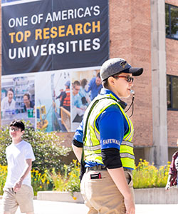 A student safety officer stands on duty.