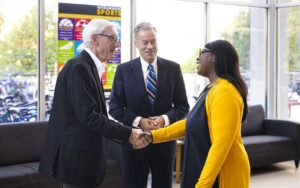 UWM Director of University Housing Arcetta Clay Jones greets Gov. Tony Evers and Chancellor Mark Mone during their Tuesday morning tour of Sandburg Hall.