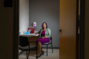 UWM nursing professor Penninah Kako sits in a room to care for patients.