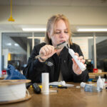 Biomedical engineering student Greta Boehm works on a medical device in UWM's engineering Makerspace