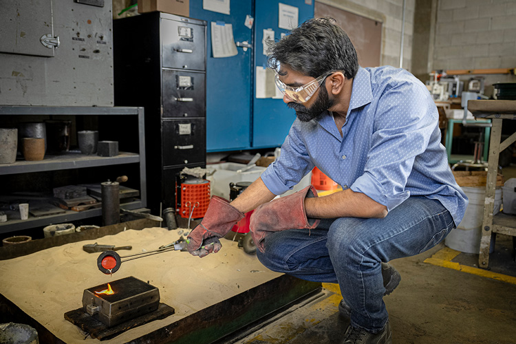 Swaroop Behera, a doctoral student in materials science, pours molten tin into a mold.