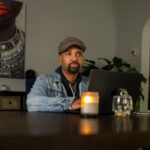 English professor Derrick Harriell works on his laptop at his home in Shorewood where he often writes his poetry.