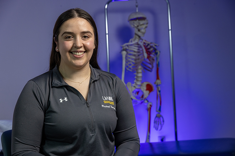 Vanity Conroy- Muñoz stands in front of a skeleton