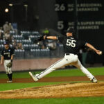 A man takes a long stride toward home plate while pitching.