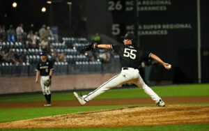 A man takes a long stride toward home plate while pitching.