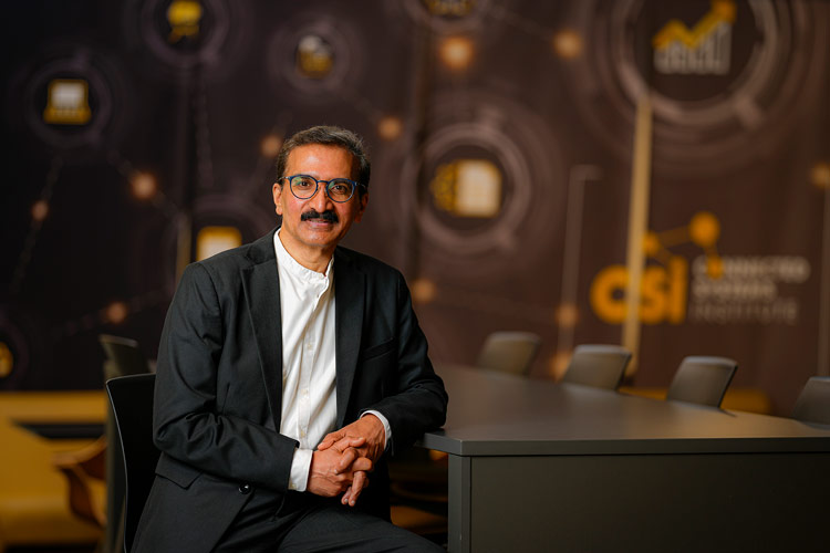 Dijo Alexander smiles while posing for a portrait at the Connected Systems Institute