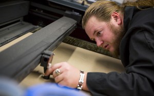Engineering graduate student Joe Patzer gets to work in architecture’s Rapid Prototyping Lab. (UWM Photo/Derek Rickert)