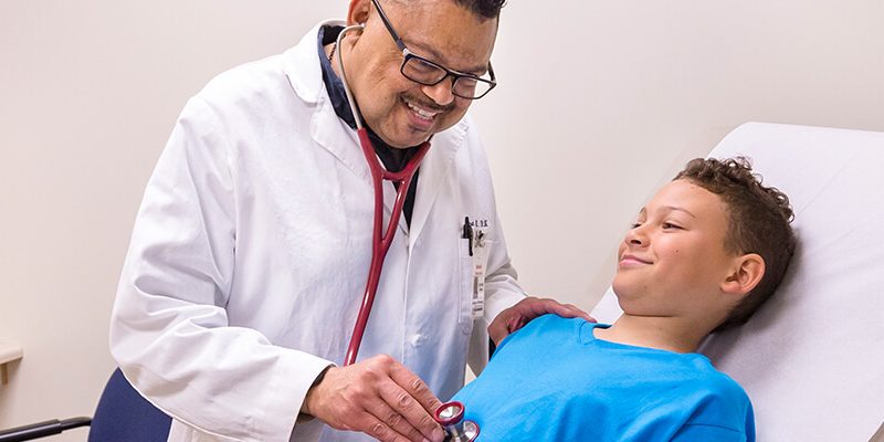 Family Nurse Practitioner treating a male child patient