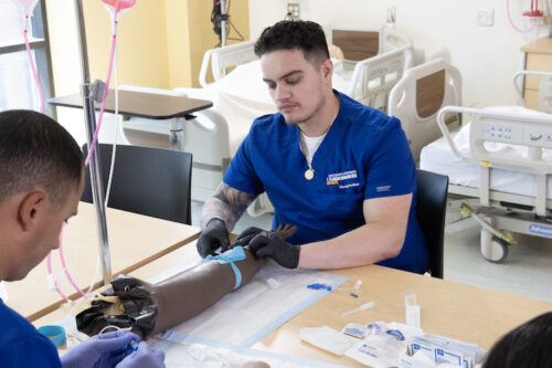 image of a nursing student tying a tourniquet