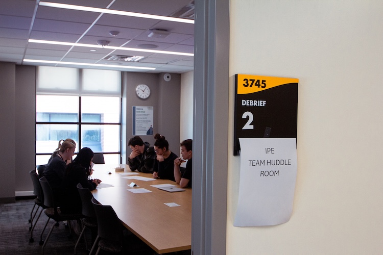 students discussing and sitting at a table